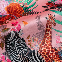 Close-up of giraffe and zebra among blooming flowers on Wild Blooms African animal and floral print velvet fabric in pink