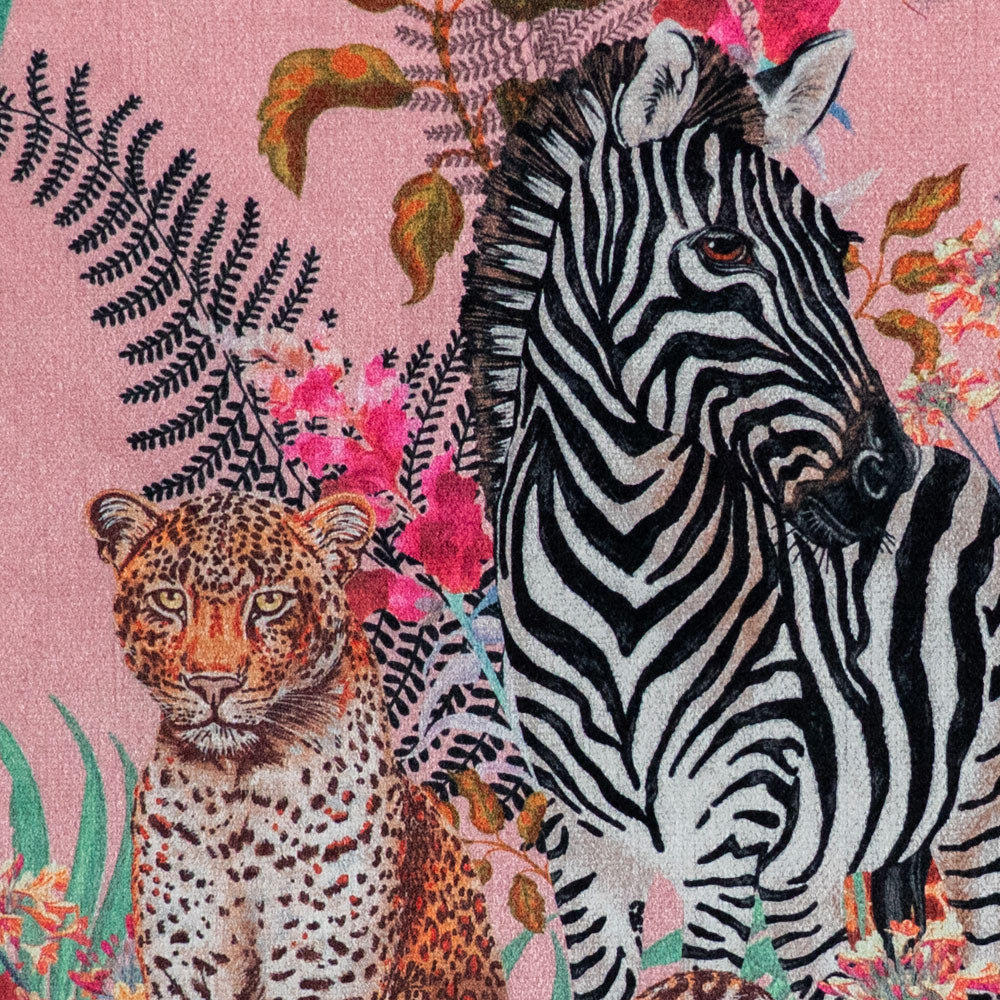 Detail of the zebra and leopard on pink African animal and floral print velvet furnishing fabric