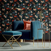 Bengal Rose Garden Dark Floral Wallpaper shown on wall with Blue Chair and Footstool