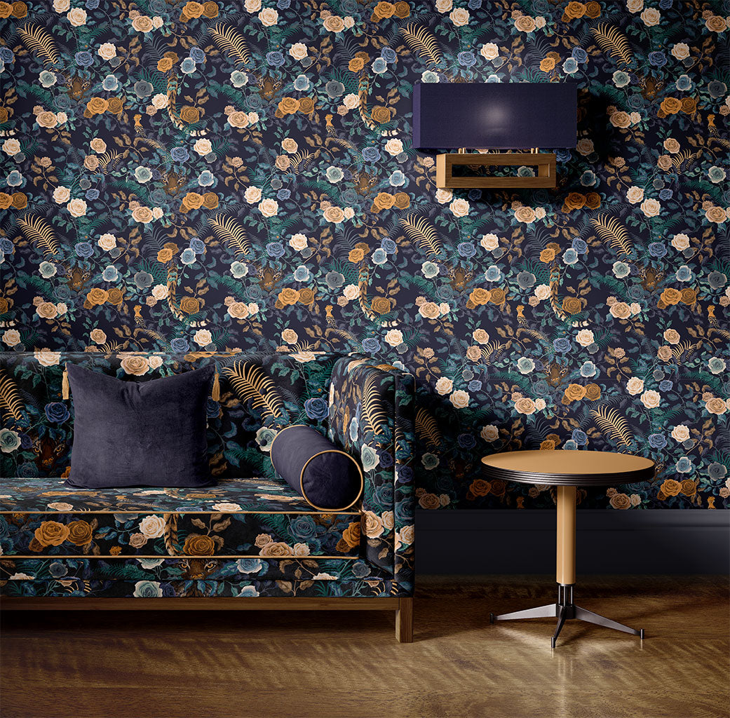 Bengal Rose Garden velvet upholstered sofa in front of matching wallpaper designed by Becca Who