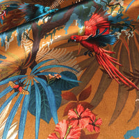 Designer fabric for upholstery and soft furnishings with Rainforest Birds design in Mustard Yellow.